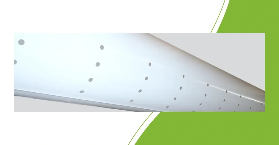 Close-up of a transparent air distribution duct with round outlet holes