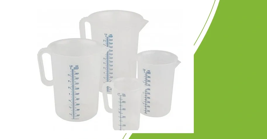 Measuring jugs with graduated scales and handles on a green background; illustrative group photo, not a set